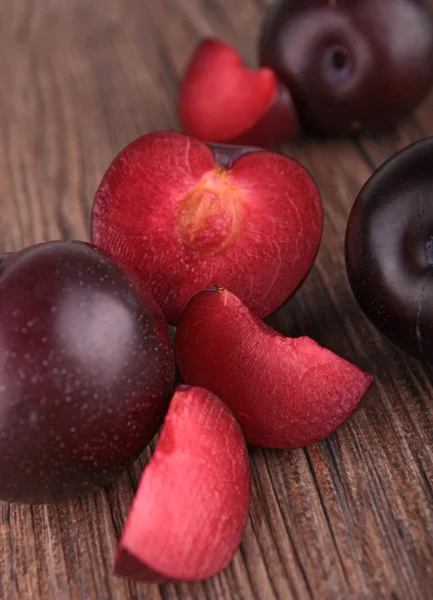 Red plum fruit on wooden background — Stock Photo, Image