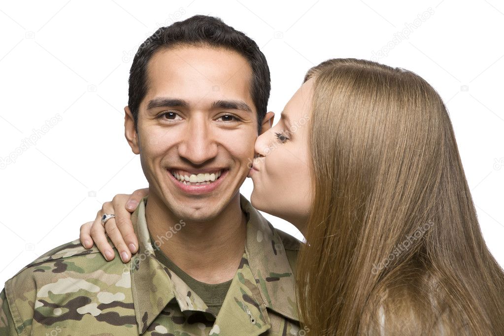 Woman Kisses Latino Serviceman on the Cheek