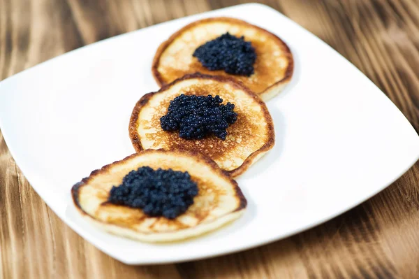 Pancakes with black caviar — Stock Photo, Image