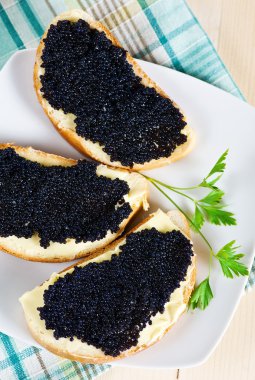 Black caviar on a slice of bread and butter