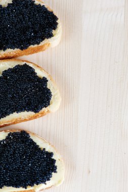 Black caviar on a slice of bread and butter