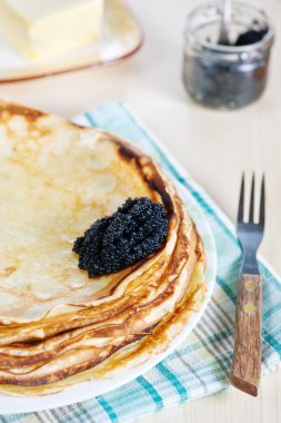 Pancakes with black caviar clipart