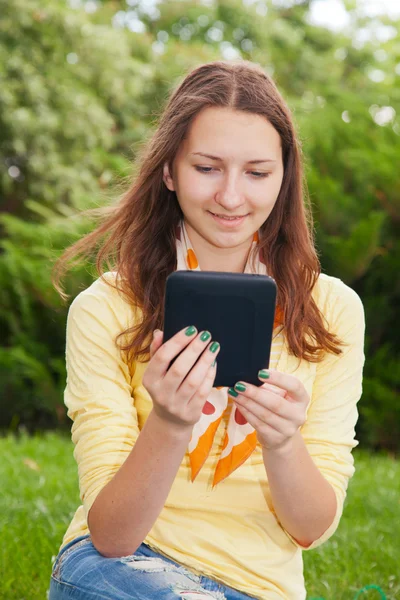 Adolescente chica leyendo libro electrónico —  Fotos de Stock