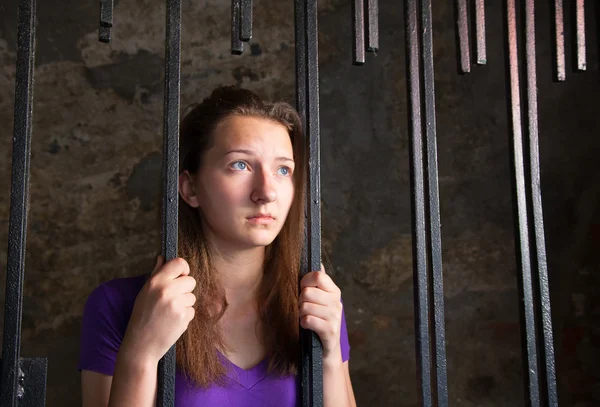 Young woman behind the bars — Stock Photo, Image