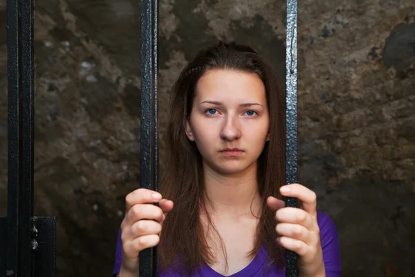 Young woman behind the bars — Stock Photo, Image