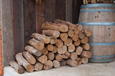 Snow log stack lumber in winter. Woodpile of pine clipart