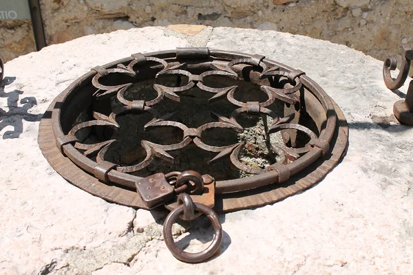 stock image Wrouhtg iron grille on the old pit