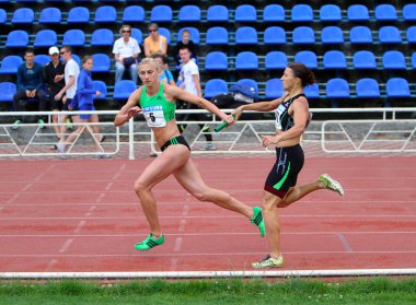Antonina Efremova and Olishevska Yulia compete at the relay race on Ukrainian Cup in Athletics, on May 29, 2012 in Yalta, Ukraine clipart