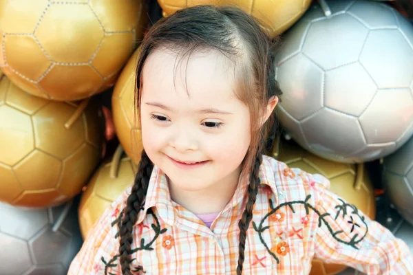 The little girl on the background of soccer balls. — Stock Photo, Image