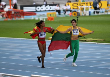 Ana Peleteiro and Dovilé Dzindzaletaité celebrate the gold and silver medal in triple jump on 2012 World Junior Athletics Championships on July 12, 2012 in Barcelona, Spain clipart