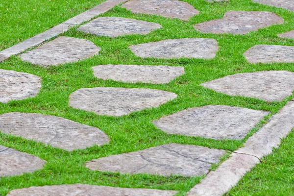 Stock image Stone path on green grass