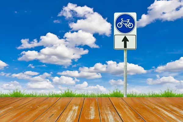 Drewno rowerów sposób i znak przeciw błękitne niebo — Zdjęcie stockowe