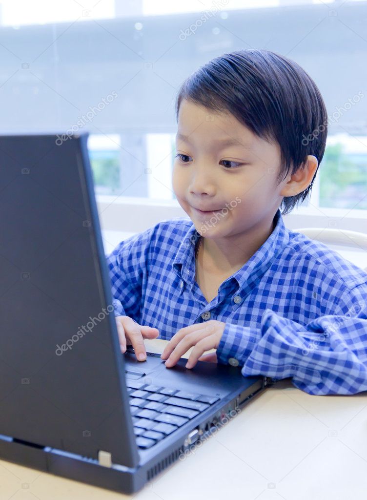 Asian kid with laptop notebook