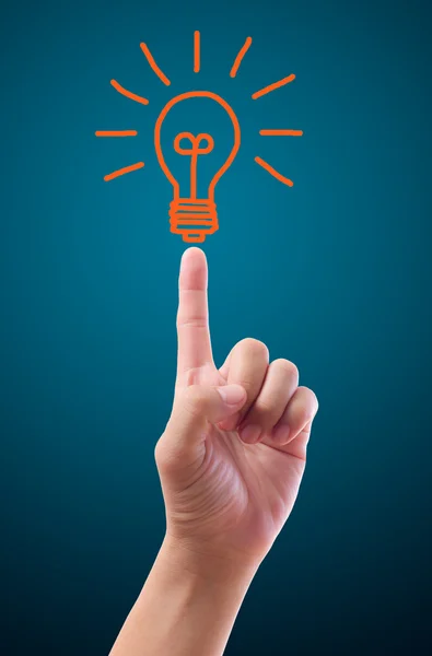 Hand pointing to light bulb — Stock Photo, Image