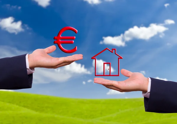 Hand exchange euro sign and house icon — Stock Photo, Image