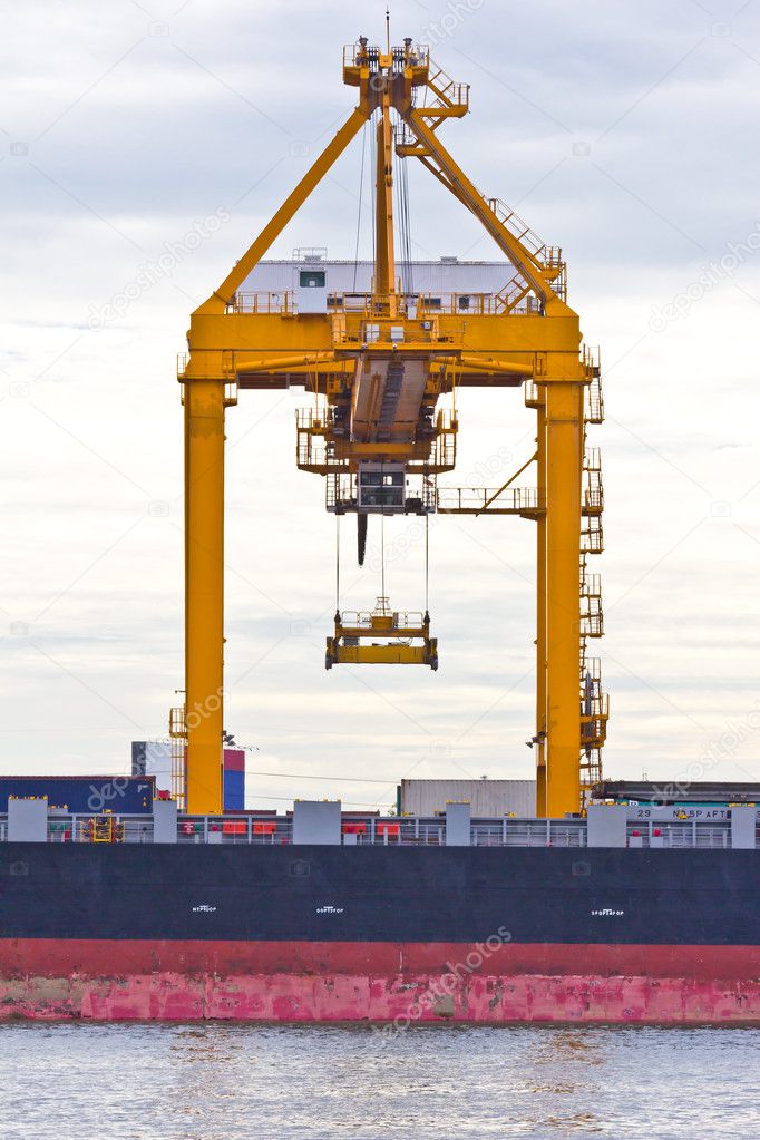 Crane working with container cargo in shipyard