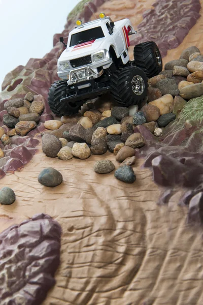 White truck drive through rocks
