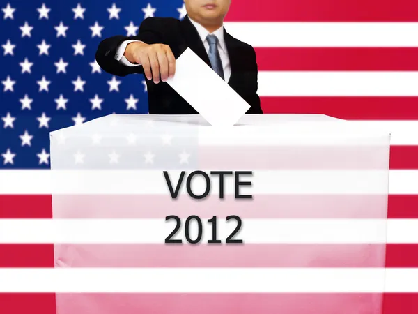 Gentleman hand putting a voting ballot in slot of white paper bo — Stock Photo, Image
