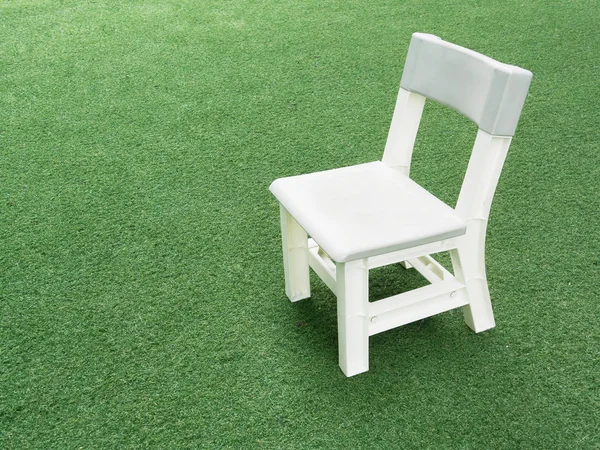 Stock image White child chair on green grass