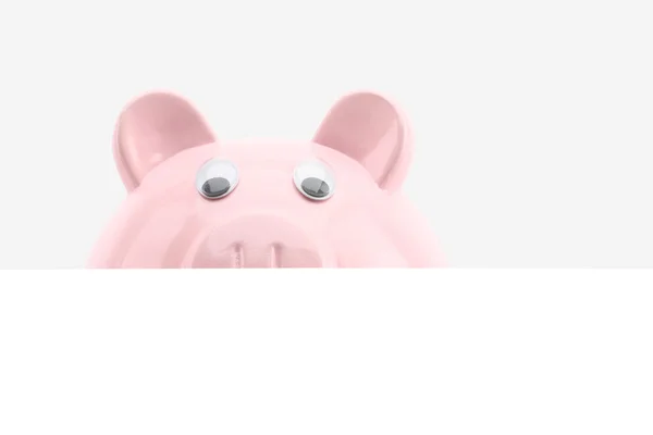 Piggy bank hiding behind a banner isolated on white — Stock Photo, Image