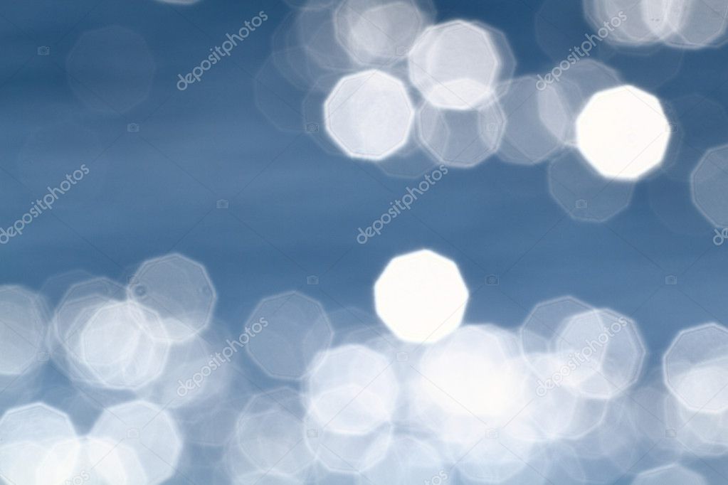 Background of blue water with sun reflections