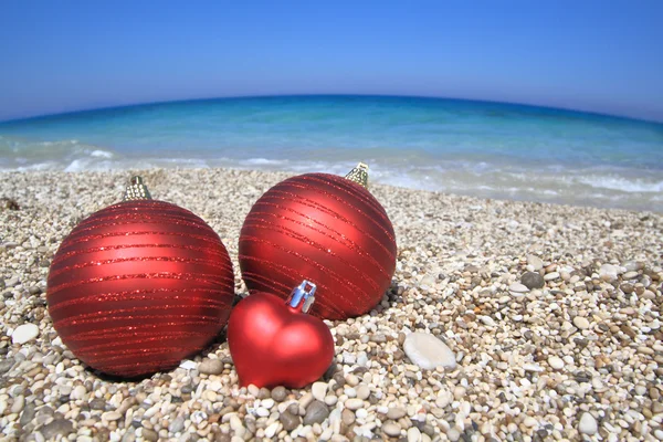 Christmas balls on the beach — Stock Photo, Image