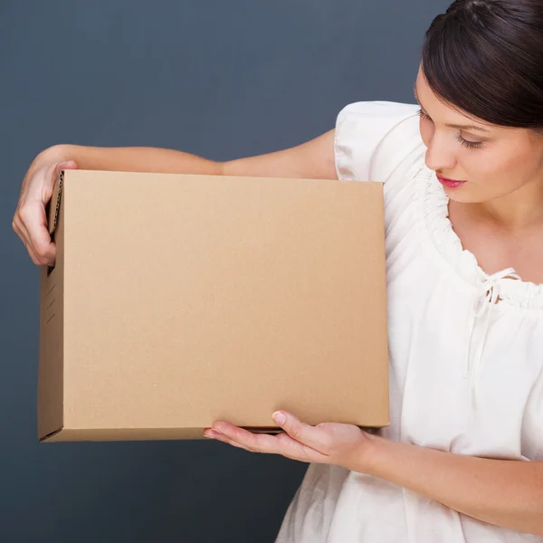 Closeup portrait of a young woman with box — Stock Photo, Image