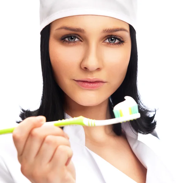 Стоматолог держит зубную щетку на белом фоне — стоковое фото