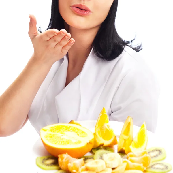Professional Cook with plate of fruits sending an air kiss, isol — Stock Photo, Image