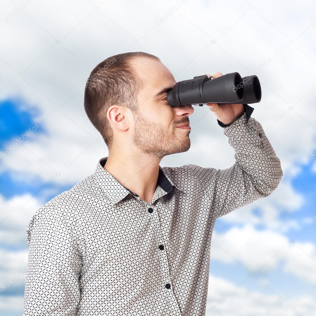 Business man with binoculars looking to the future or looking fo