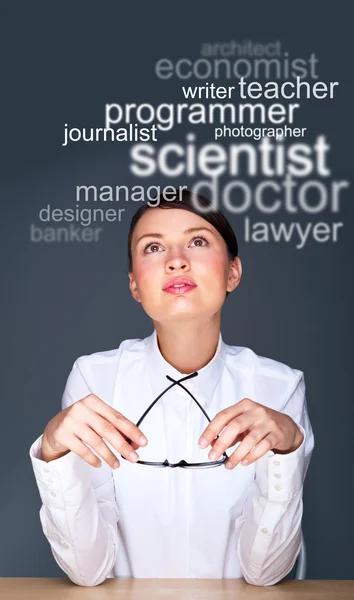 stock image Young businesswoman sitting at her office and thinking about sta