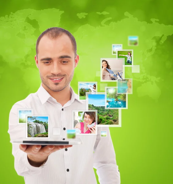 Portrait of young happy man sharing his photo and video files in — Stock Photo, Image