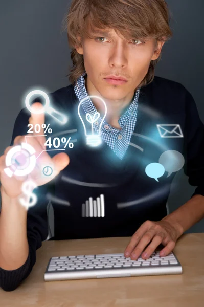Adult business man working with his computer and different icons — Stock Photo, Image