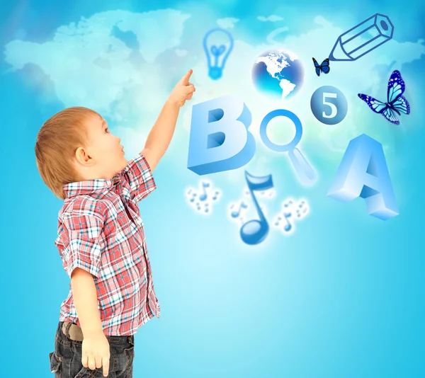 Happy little boy pointing up. Icons of different lessons flying near him. Primary education — Stock Photo, Image