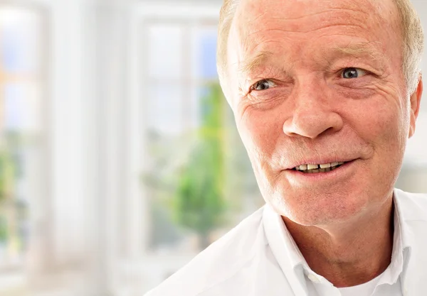 stock image Old man is very happy with his new apartment in modern building.