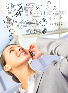 Portrait of beautiful business woman on the phone at modern buil clipart