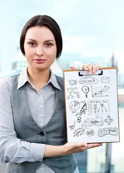 Business woman holding papers with sketches for her business — Stock Photo, Image