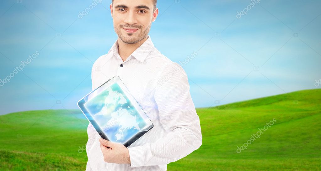 Man using his tablet computer outdoors at countryside. Mobile te