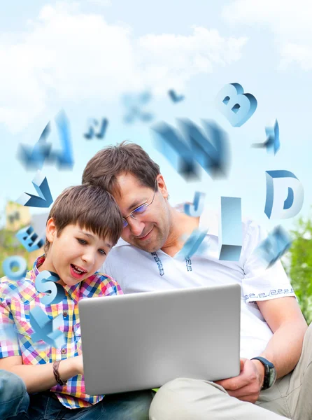 Closeup portrait of happy family: father and his son educating using laptop — Stock Photo, Image
