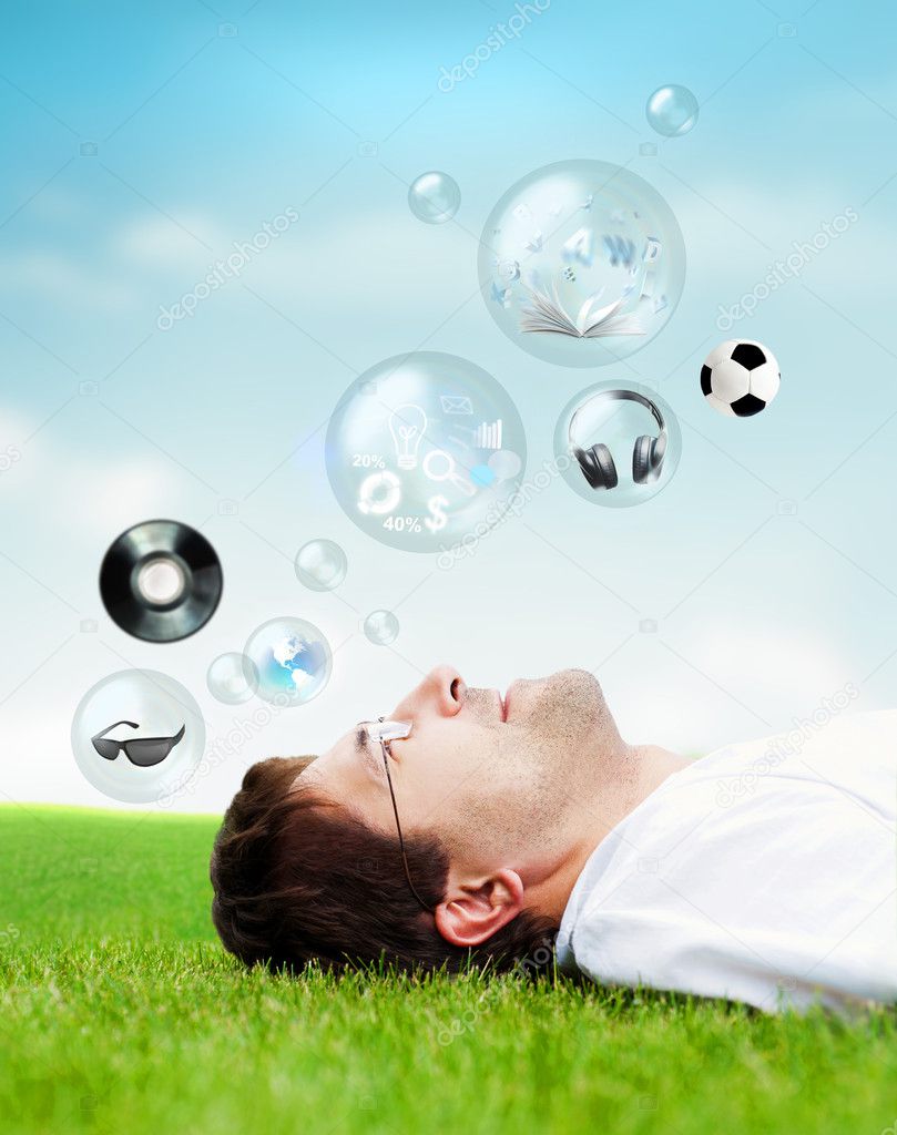 Adult man lying on grass and looking up.