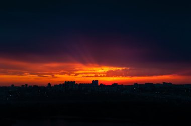 Abstract city silhouette against dramatic sky clipart