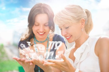 Two women mother and daughter sitting at summer park and having clipart