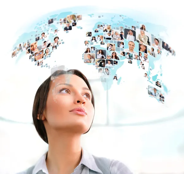 Young successful woman looking at worldmap with profile photos o — Stock Photo, Image