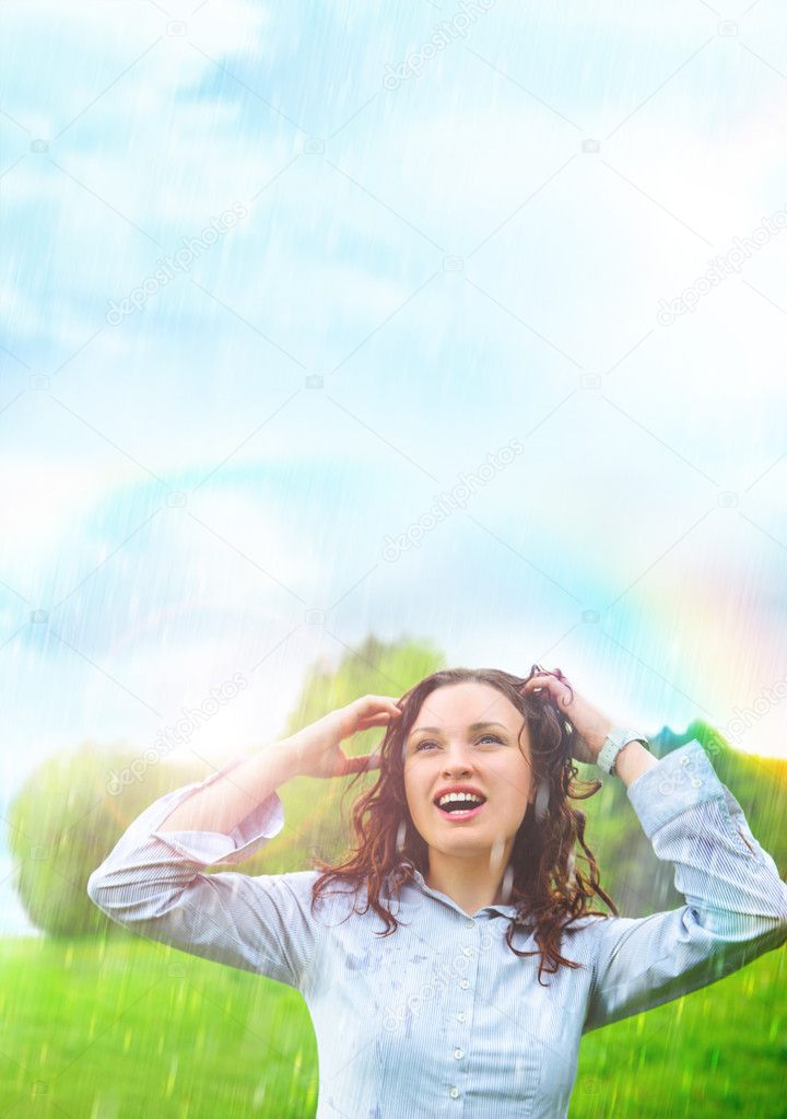 Young woman outdoors under rain against beautiful scenery