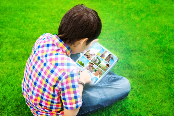 어린 소년 잔디에 앉아서 o을 태블릿 컴퓨터를 사용 하 여 — 스톡 사진