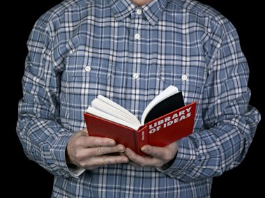 Young man reading a book for inspiration clipart