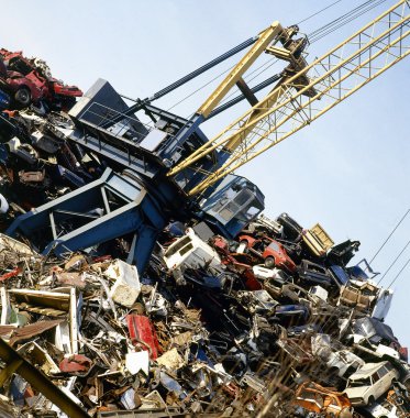 Metal recycling site over blue sky clipart