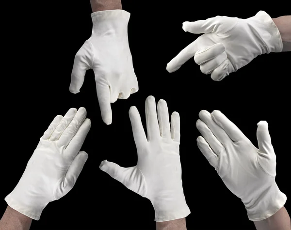Weiß behandschuhte Hand auf schwarzem Hintergrund — Stockfoto