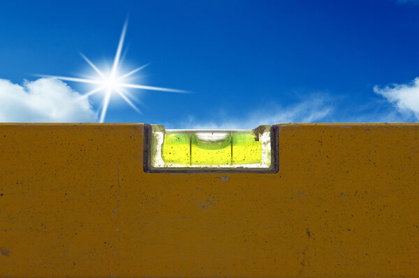 Detail of spirit level with blue sky light on background
