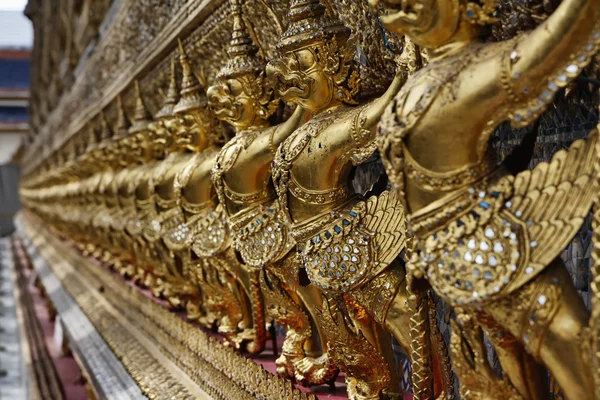 stock image Thailand, Bangkok, Imperial City, Imperial Palace, golden statues on the external wall of a Buddhist temple